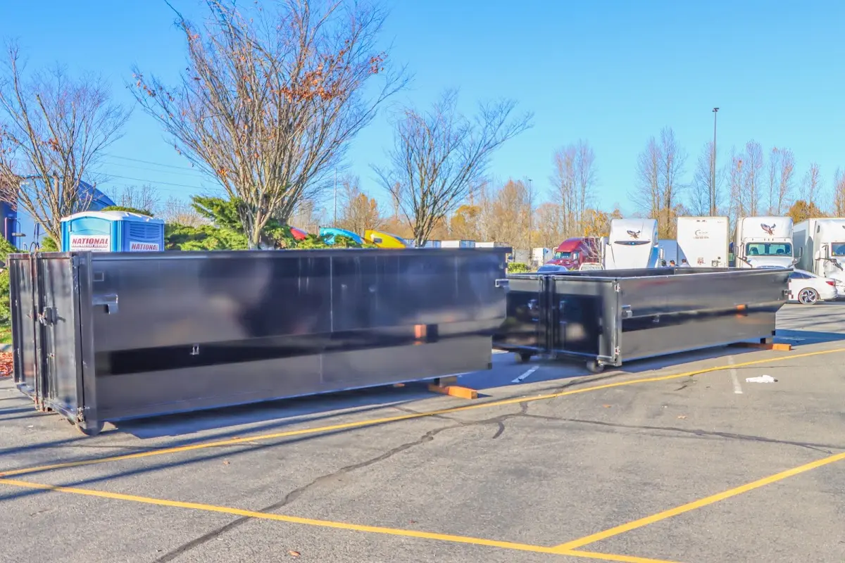 Professional dumpster rental service with roll-off container on residential driveway in Burlingame
